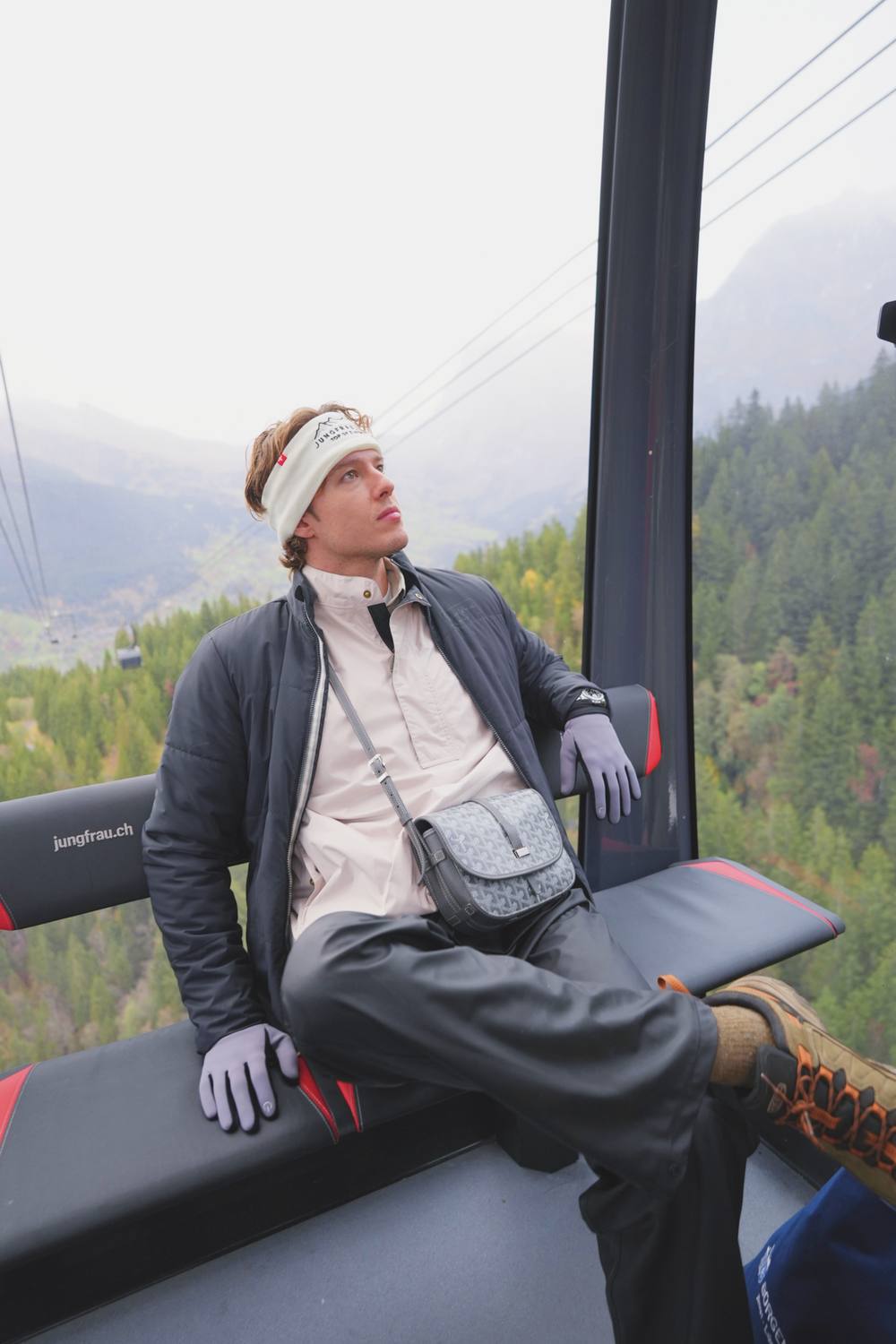 A guest riding the Eiger Express gondola up from Grindelwald in autumn