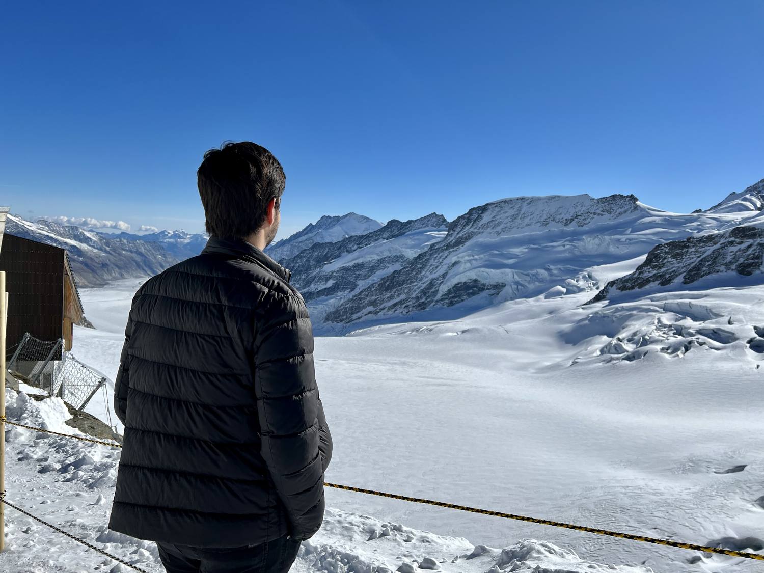 A guest on the Jungfraujoch looking out across the Aletsch Glacier