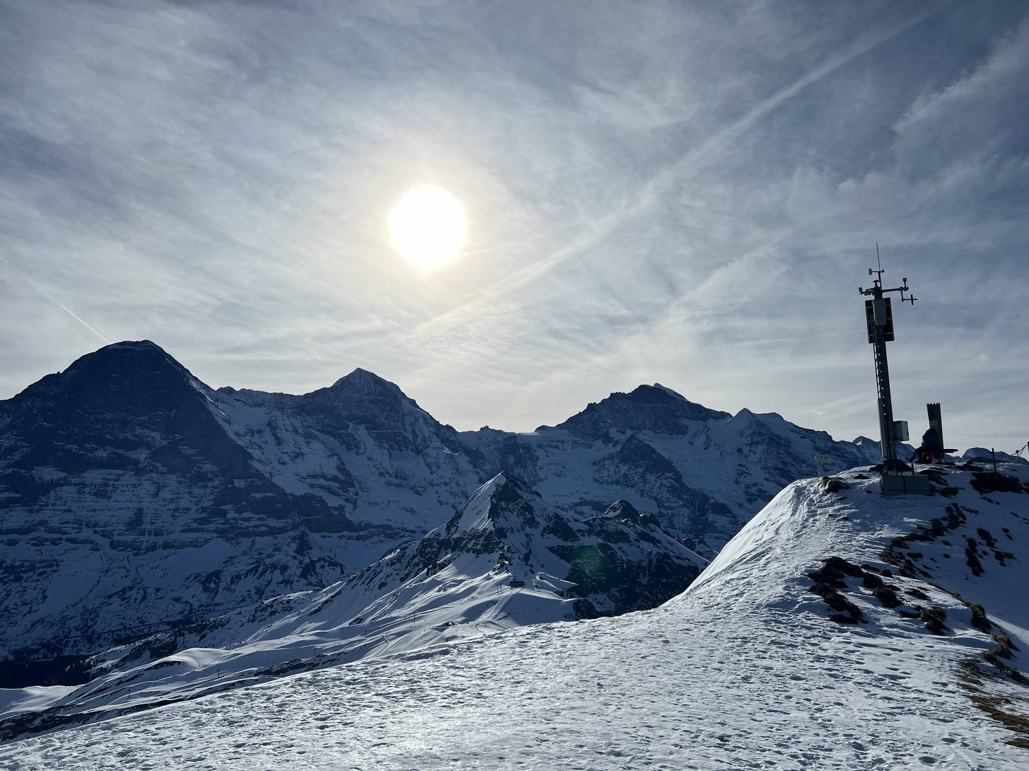 The snow-covered Männlichen summit above Grindelwald with Eiger and Mönch behind