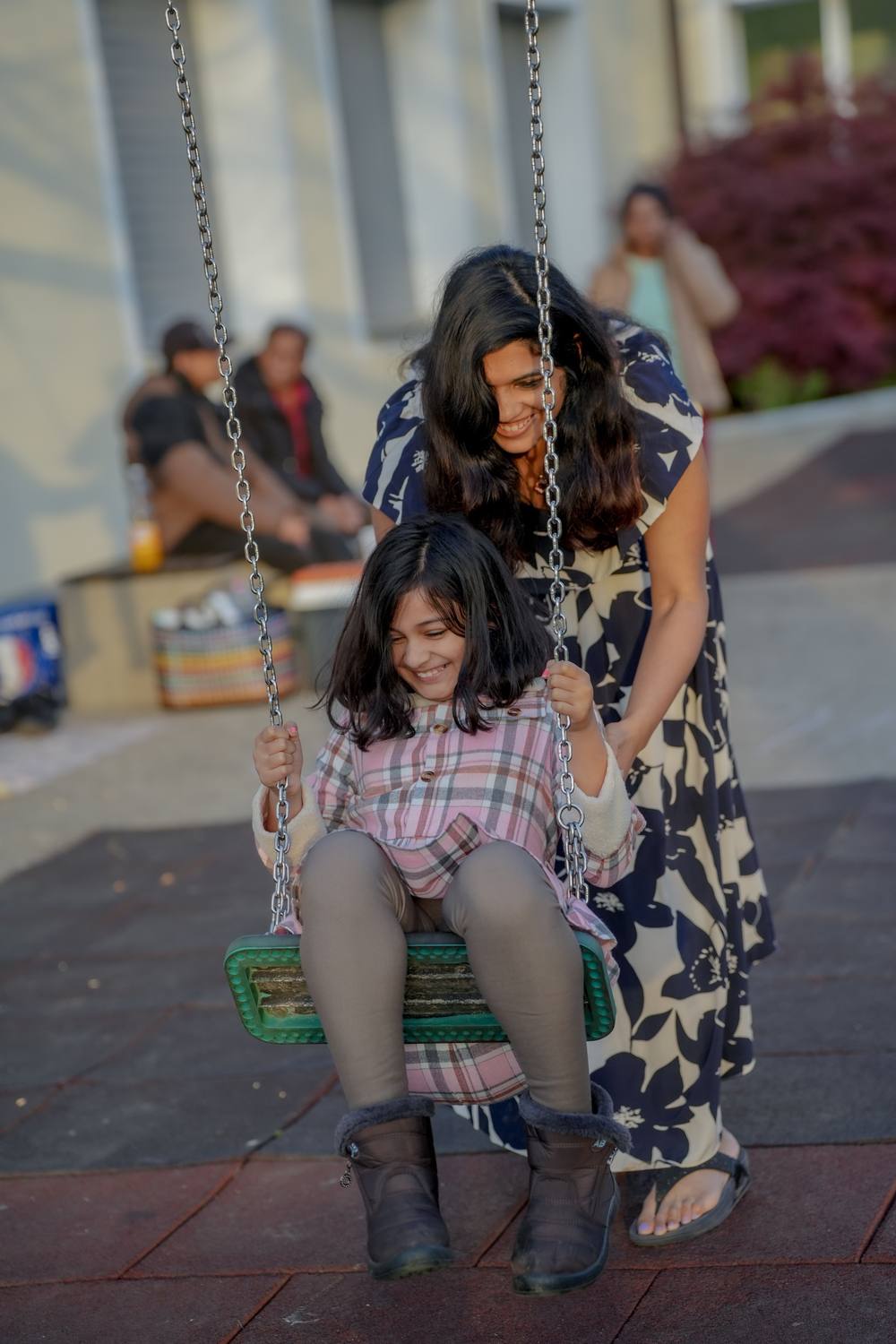 A guest pushing a child on a swing on a summer evening in Interlaken