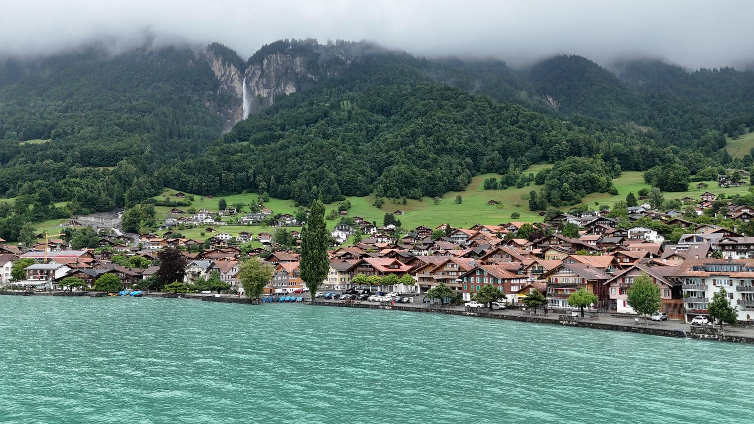 The village of Brienz along the turquoise shore of Lake Brienz below the mountains