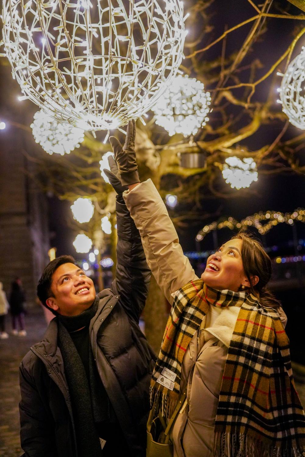 A couple under the Christmas lights of Interlaken on a winter evening
