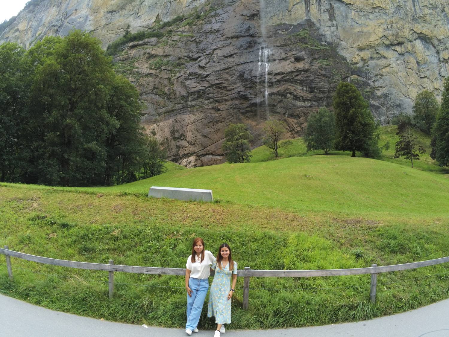 Two guests on the meadow below the Staubbach Falls in Lauterbrunnen