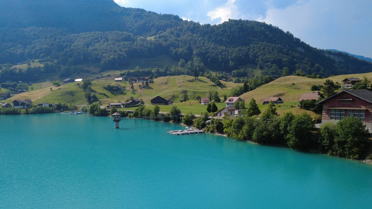 The village of Lungern on the shore of its turquoise lake, seen from the air
