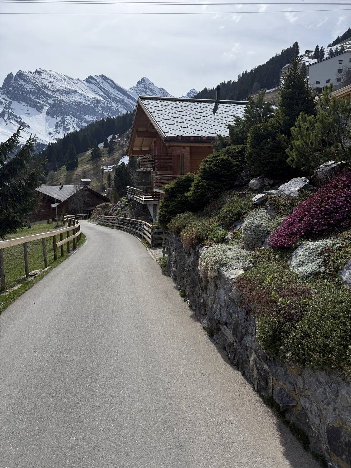 The village street of car-free Muerren with its chalets and the peaks across the valley