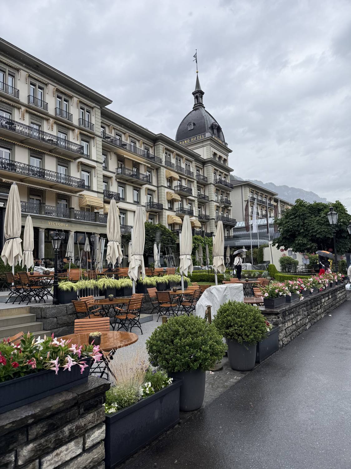 The grand hotel terrace on the Hoehematte in Interlaken, set with tables and flowers