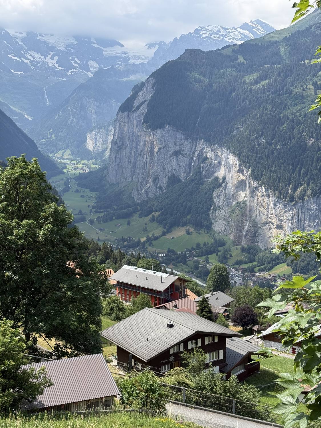 Chalet roofs in Wengen with the Lauterbrunnen valley and its cliffs below