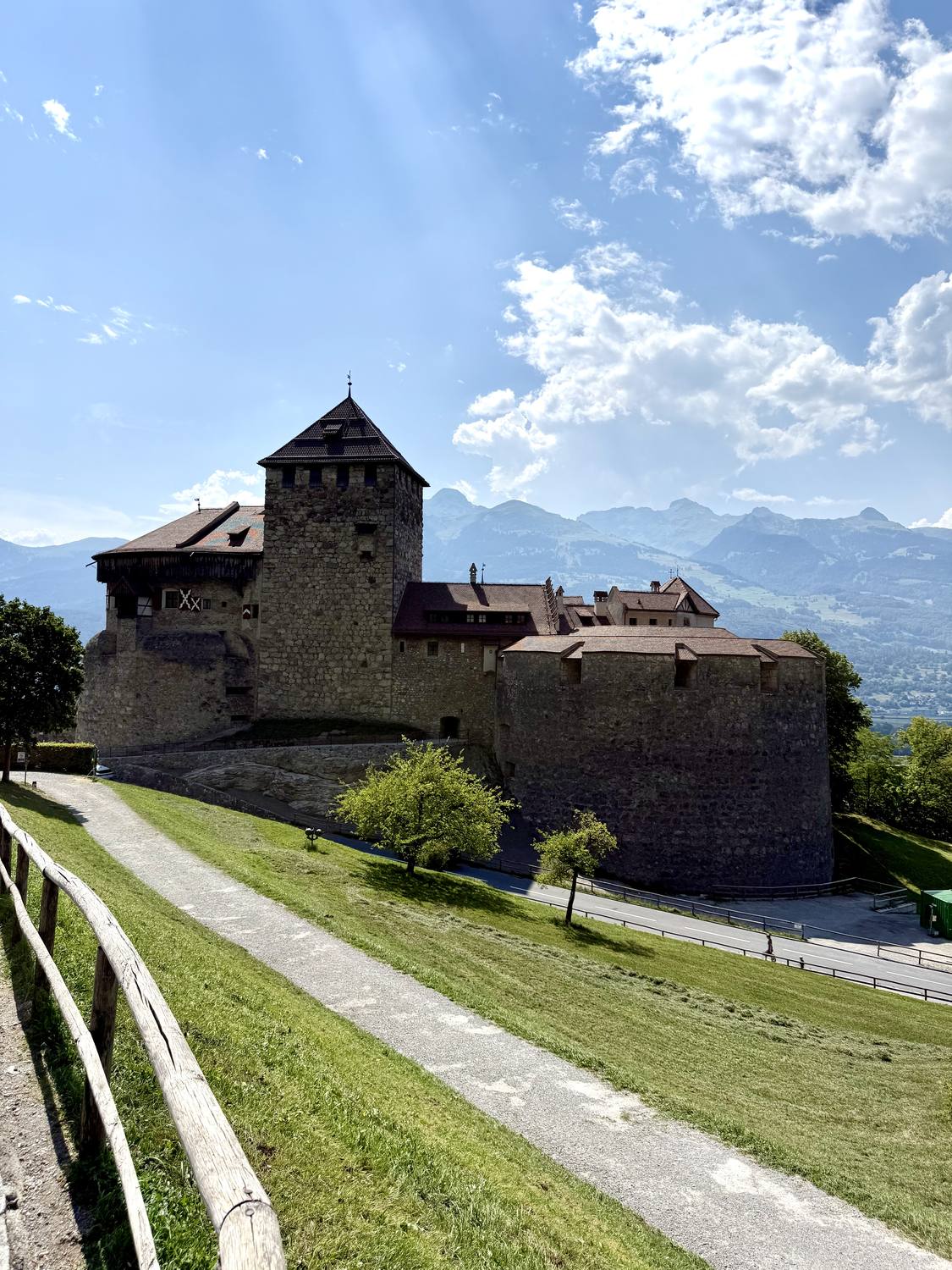 Schloss Vaduz seen from the path below, the Raetikon peaks rising behind the keep