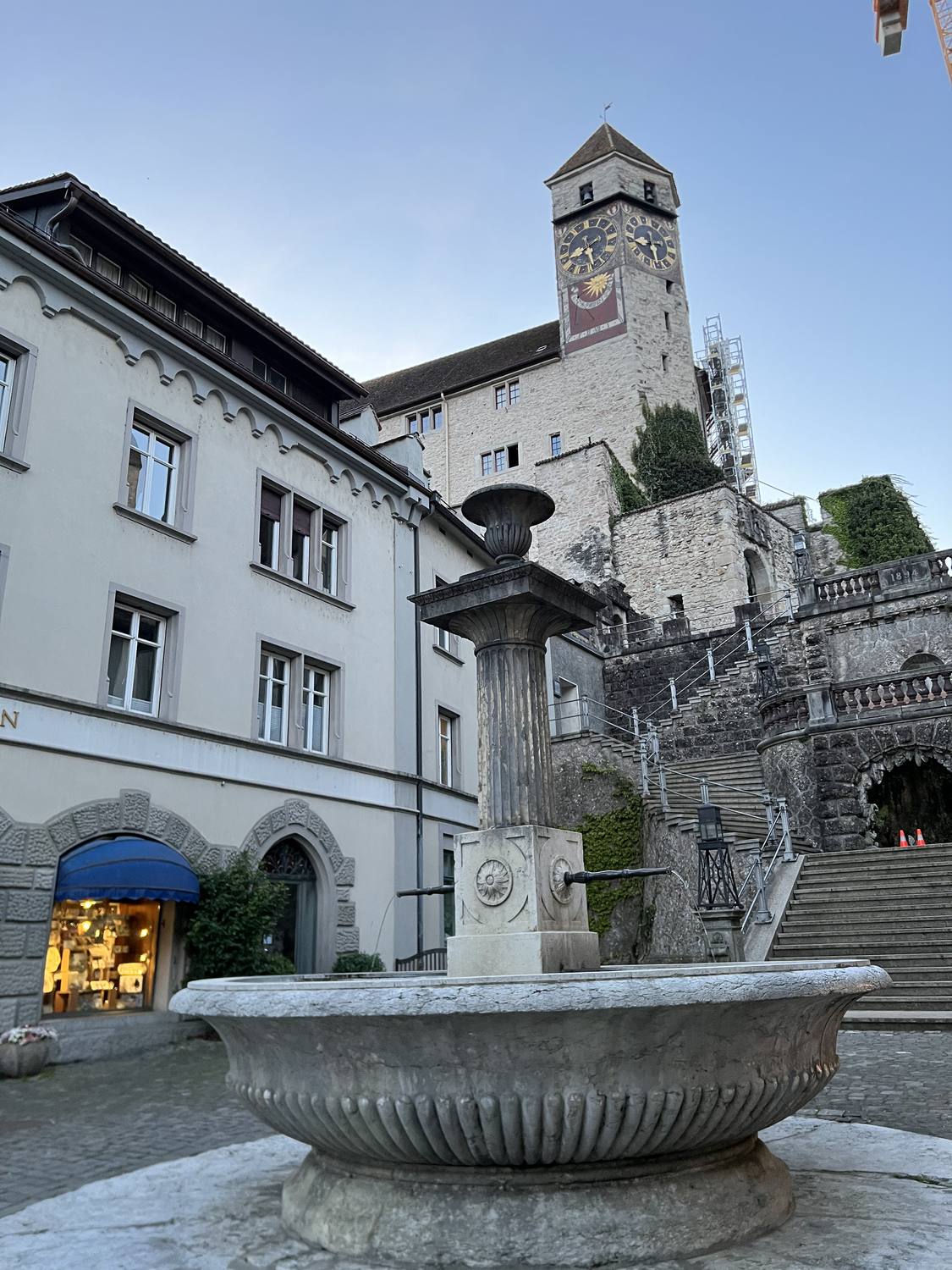 A stone fountain in Rapperswil old town below the castle tower