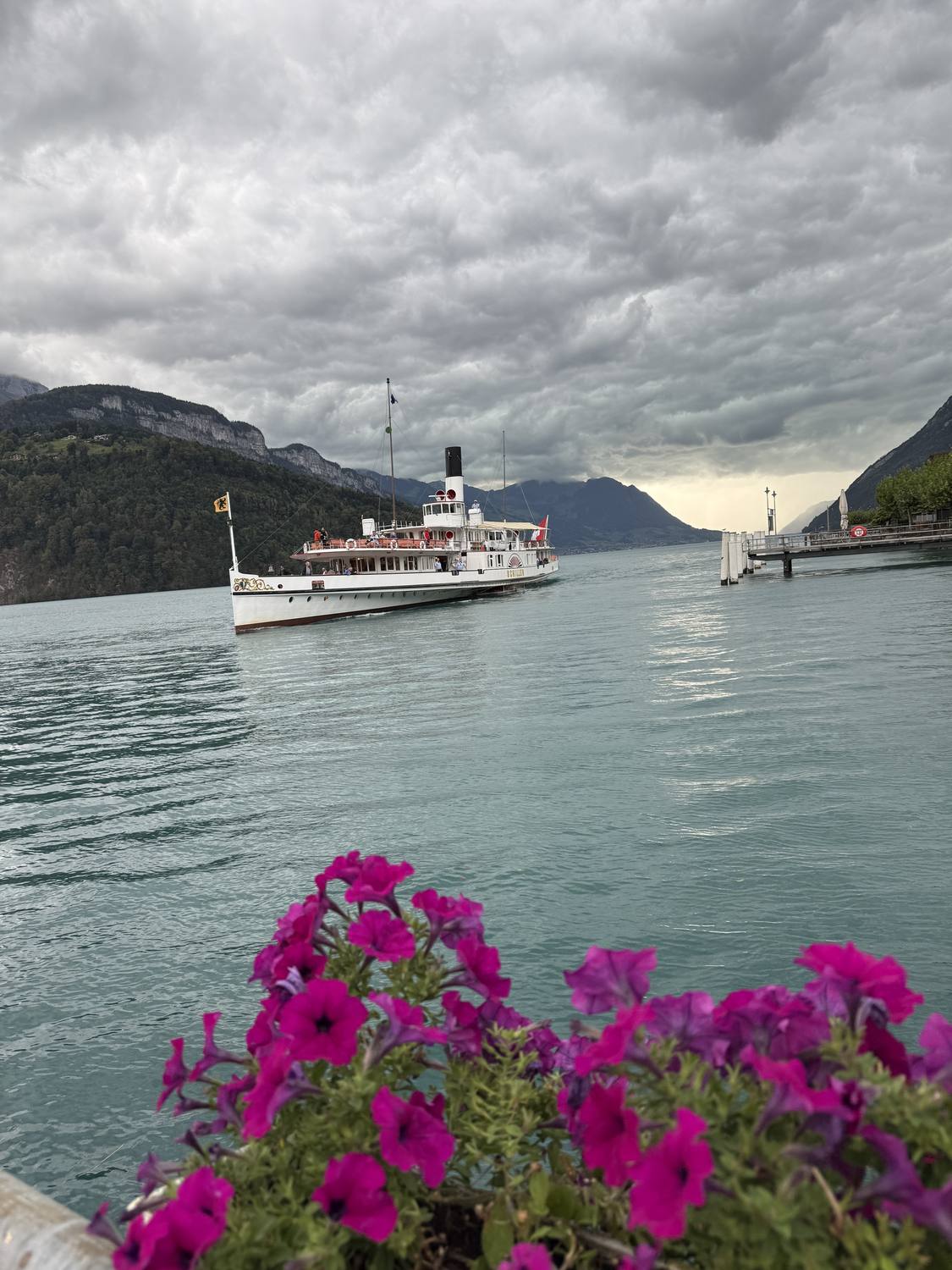 A historic paddle steamer approaching the pier on Lake Lucerne