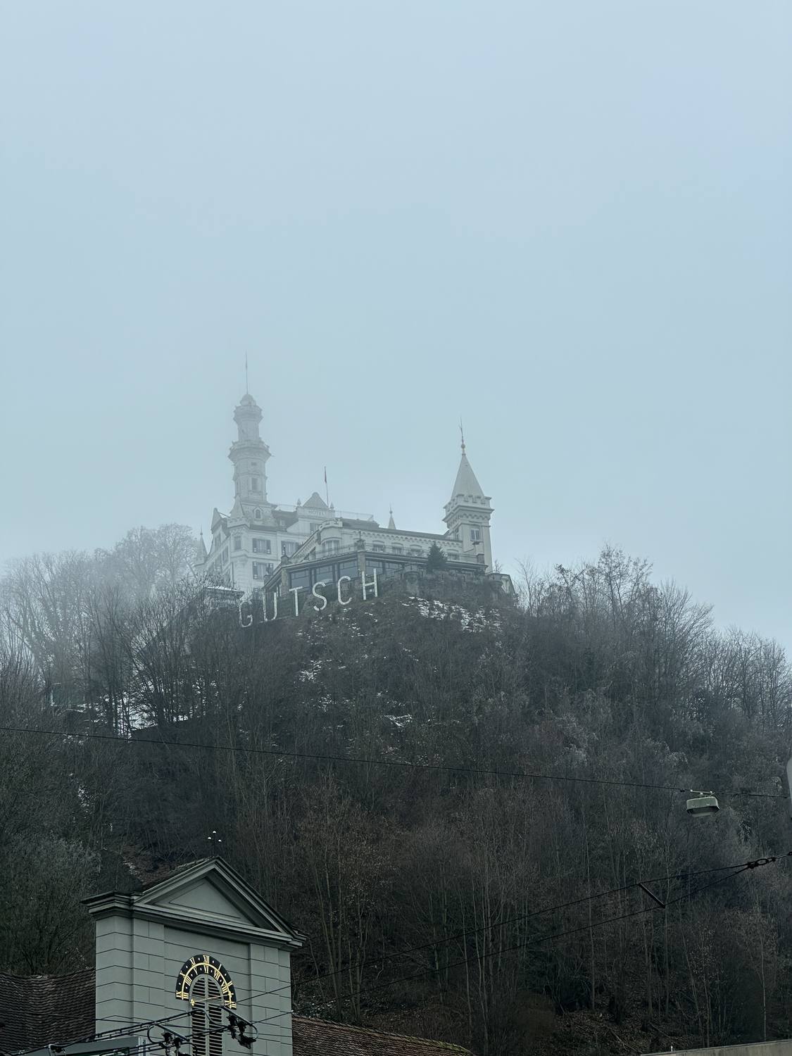 Chateau Guetsch above Lucerne emerging from winter fog over the funicular station