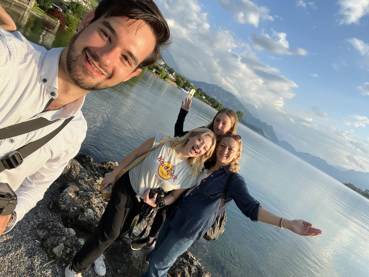 Four guests in a selfie on the shore of Lake Lucerne at Küssnacht at sunset