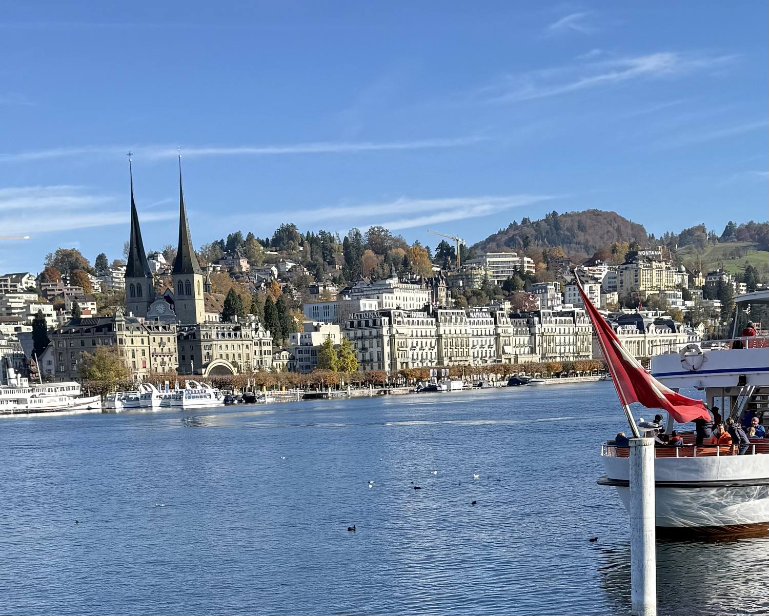 The twin towers of St. Leodegar above the Lucerne quay, seen from a steamer on the lake