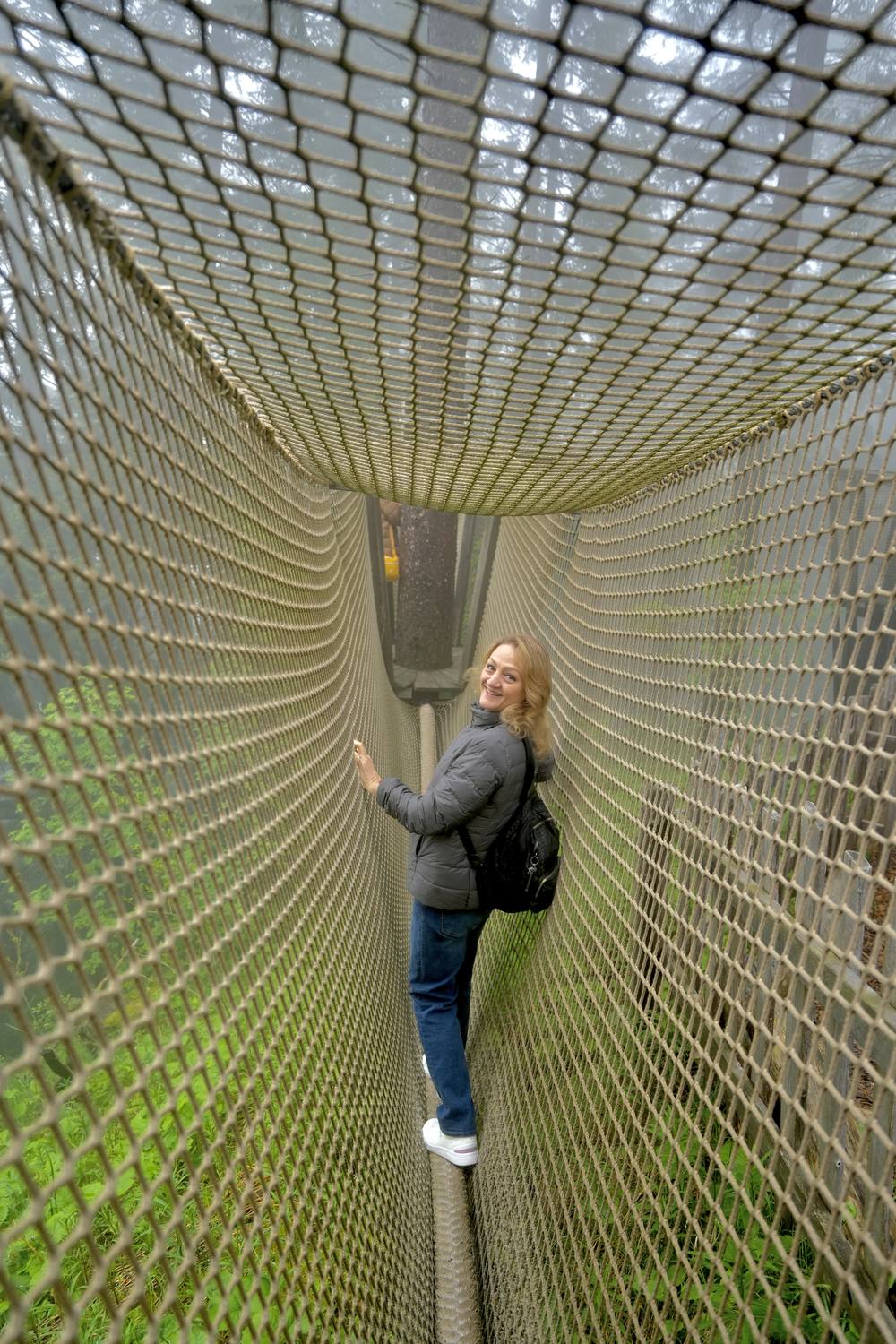 A guest inside a rope-net tunnel at the adventure park on Pilatus