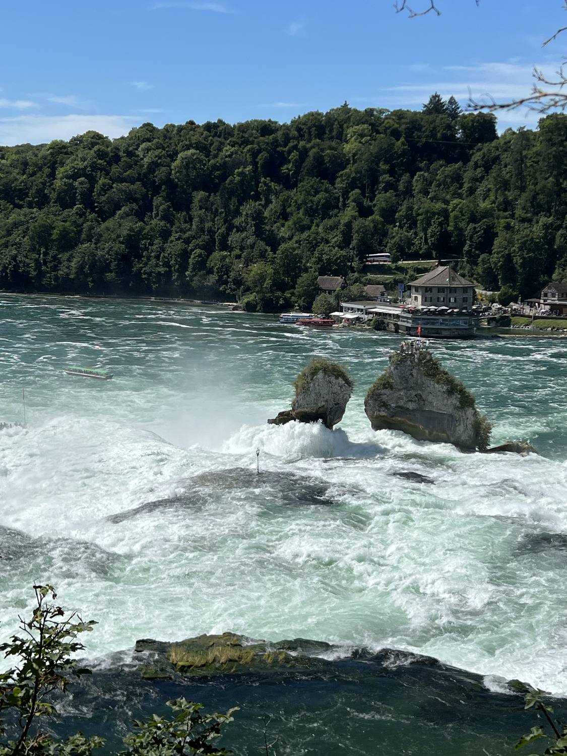 The central rock of the Rhine Falls close up, water breaking around it