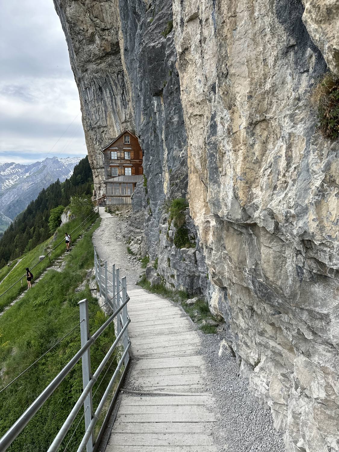The Aescher mountain guesthouse built into a cliff face in the Alpstein, Appenzell