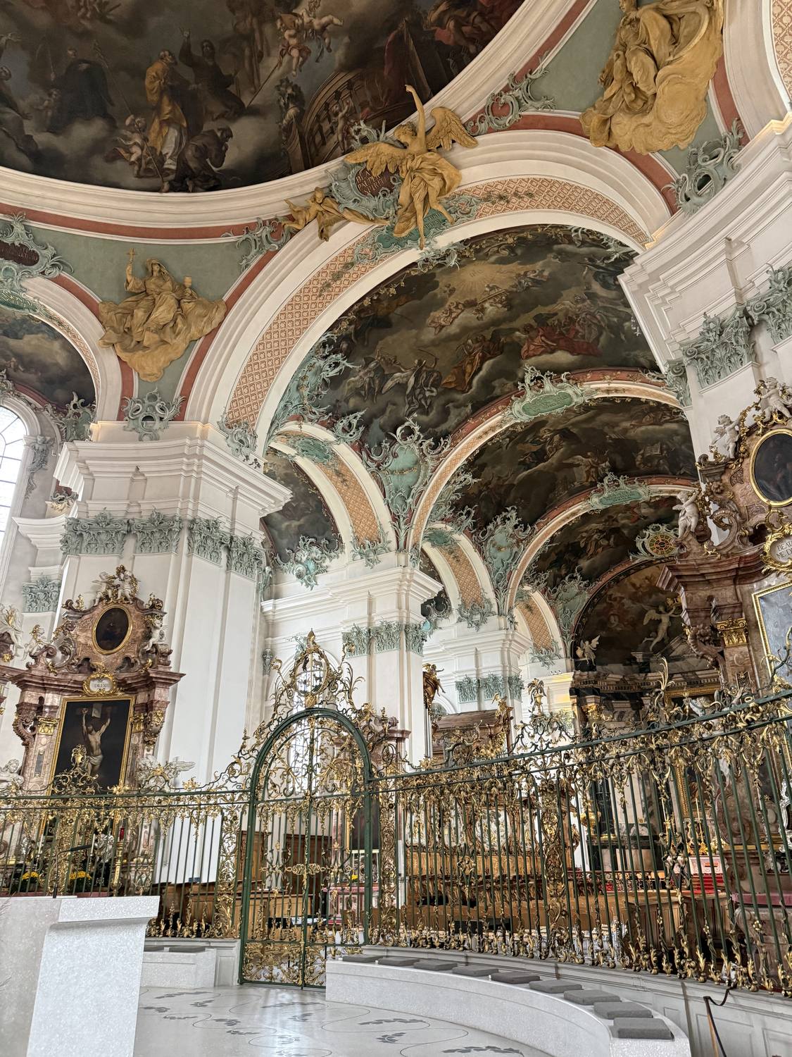 The painted vaults and gilded choir screen inside St. Gallen Cathedral