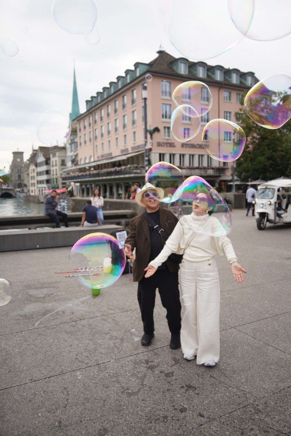 Guests walking along the Limmat river in Zurich's old town