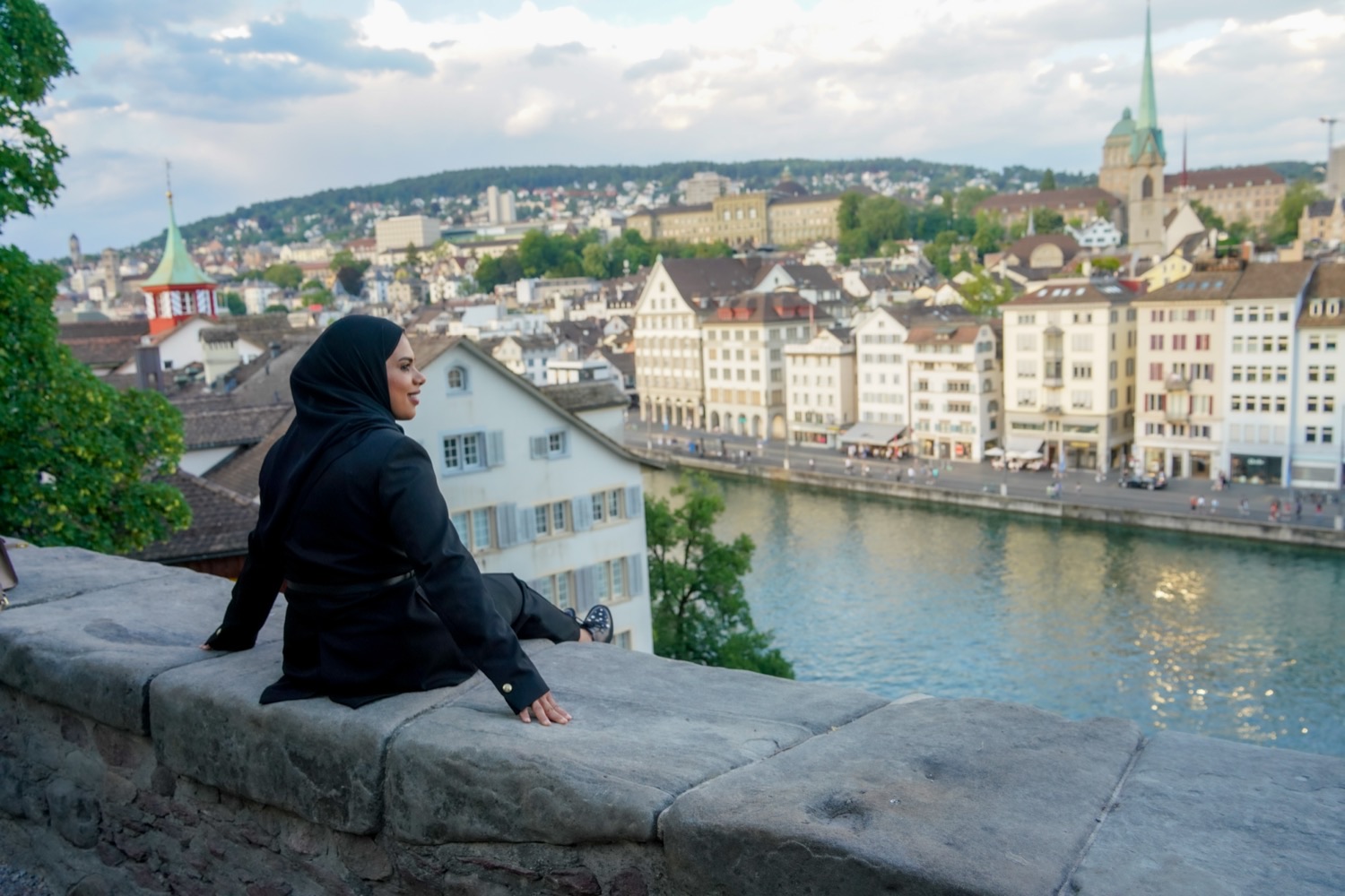 A guest taking in the view over Zurich's old town from the Lindenhof terrace