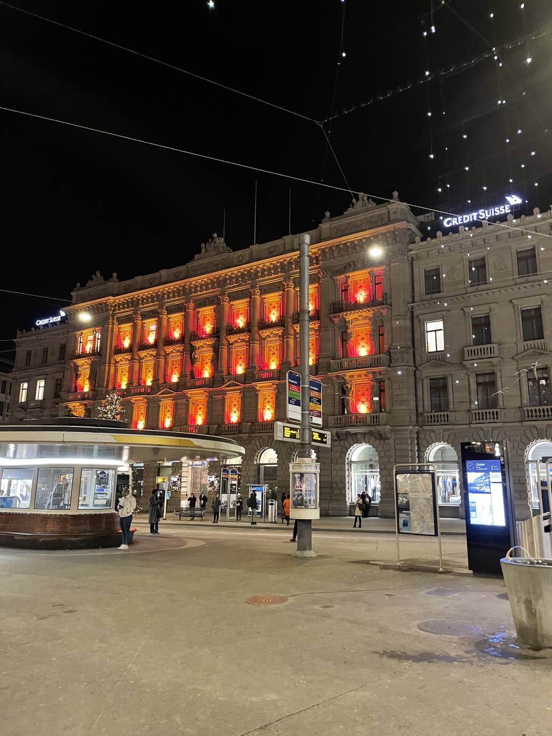 Paradeplatz in Zurich at night, the bank facades lit up in warm light
