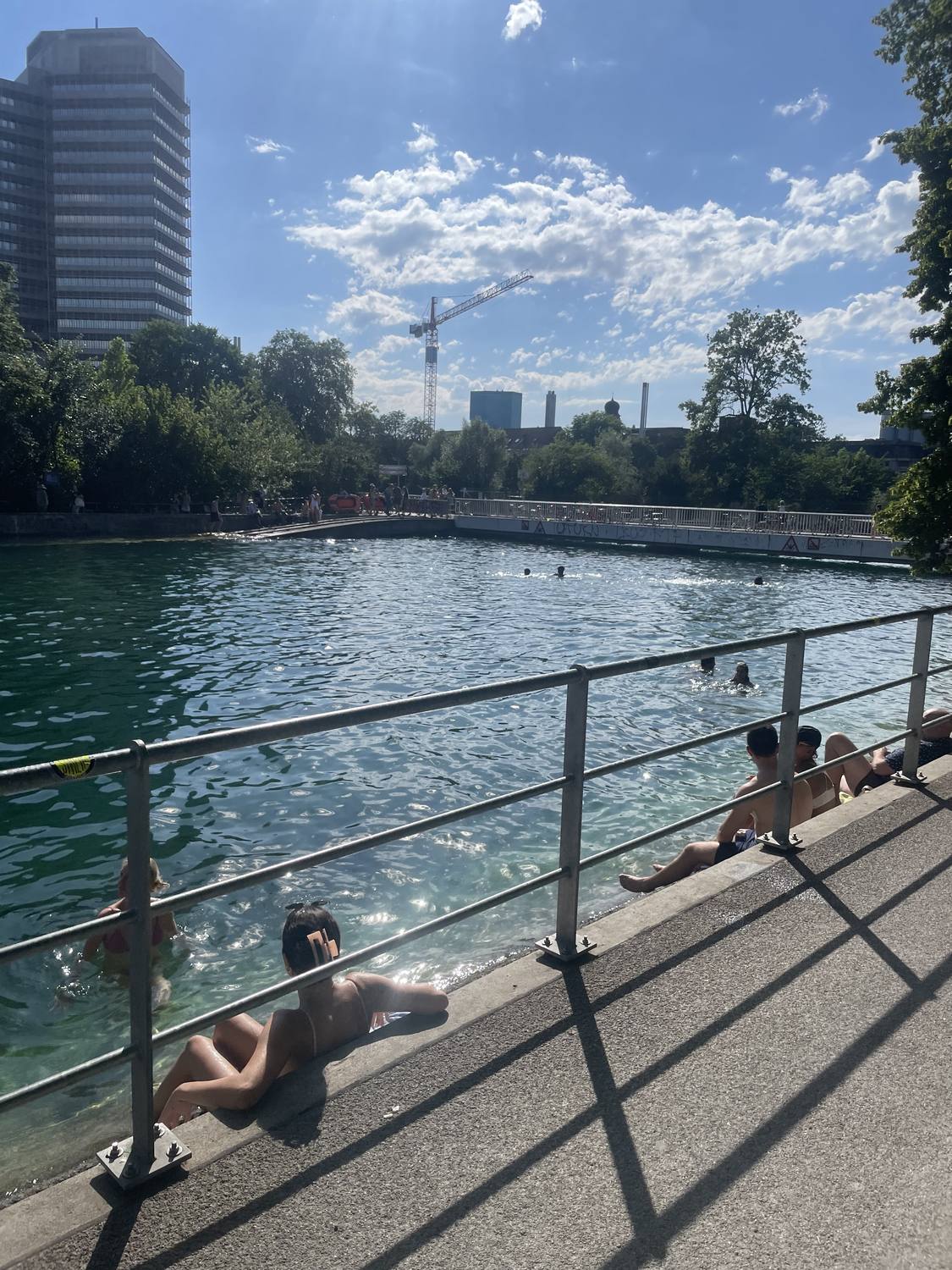 Swimmers in the Limmat at the Unterer Letten river pool in Zurich