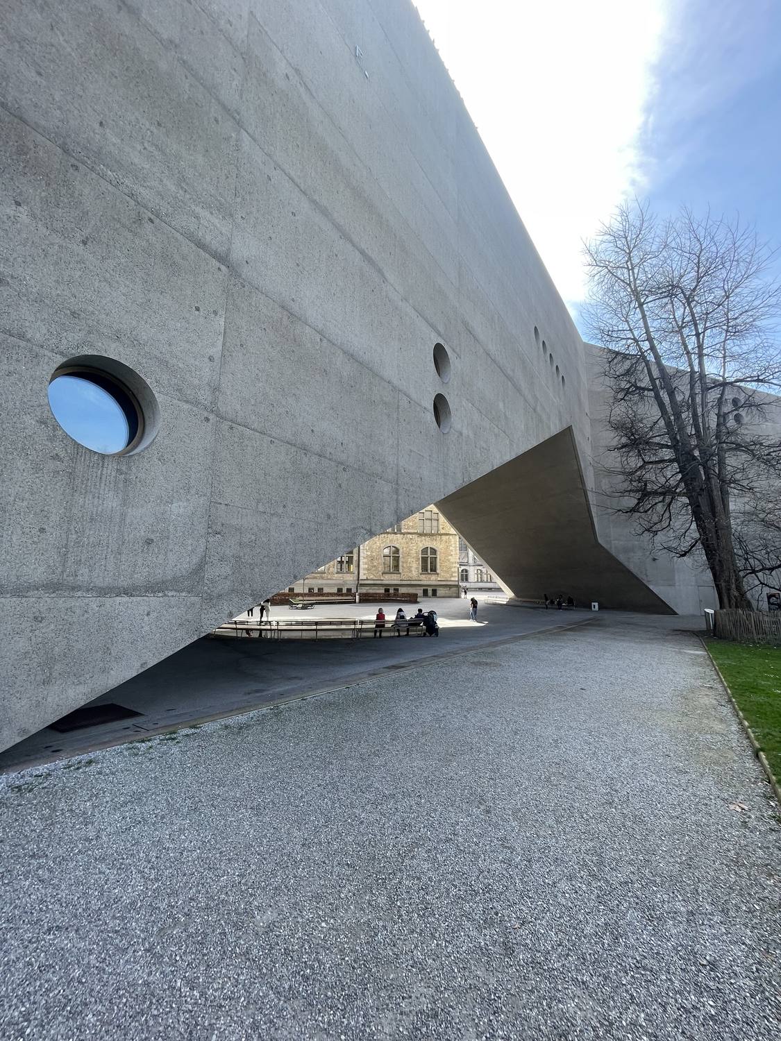 The concrete extension of the Swiss National Museum in Zurich, its round windows above the path